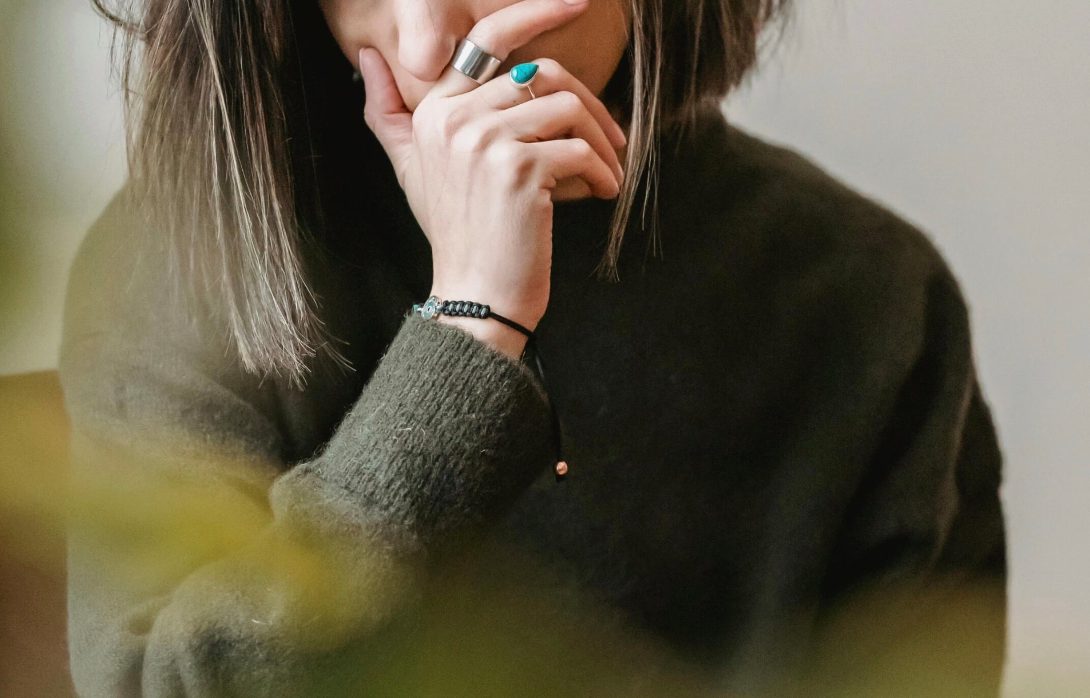 Person with hand near face in a quiet reflective moment